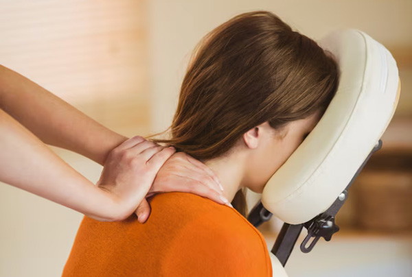woman in chair receiving shoulder massage