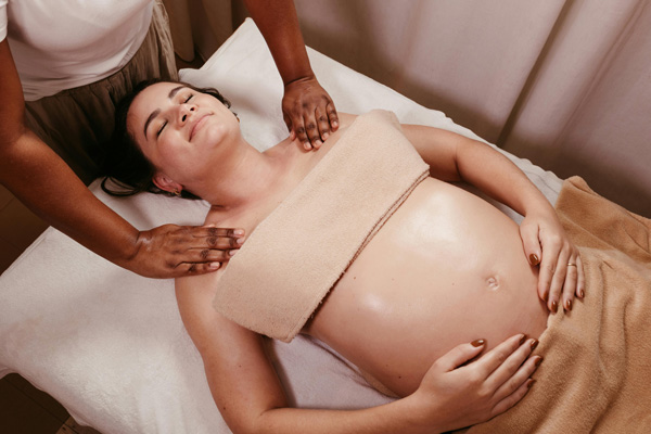 pregnant woman laying on massage bed